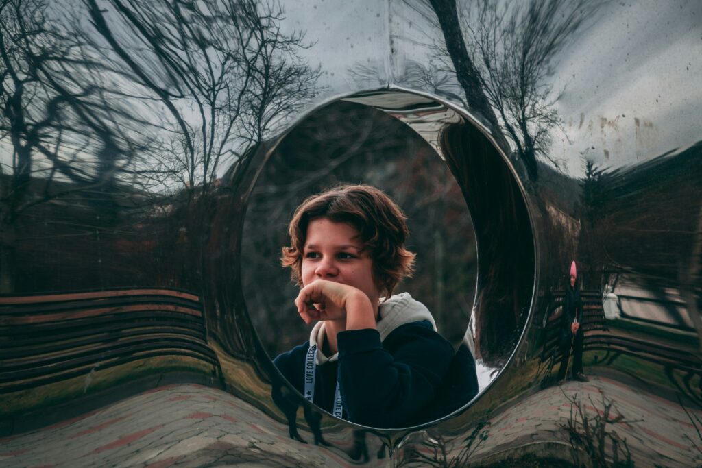 girl looking into a mirror on the road