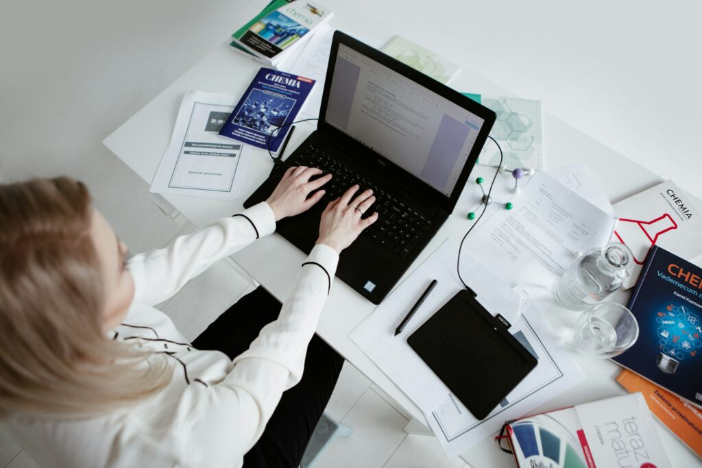 scientist working on third party testing in a lab setting on her computer